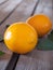 Fragrant lemons with green leaves close-up on an unpainted table