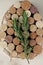 fragrant medicinal evergreen rosemary on a light background with a transparent glass and a jar of hair oil. medical plant