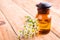 fragrant oil in a glass bottle with camomile flowers on wooden t