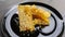 Fragrant summer honey in honeycombs, collected by domestic bees, lies on a table on a black shiny plate, ready for a healthy meal