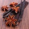 Fragrant vanilla and star anise on wooden surface plank