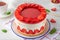 Fraisier mousse cake. Strawberry cake with biscuit, mousse and jelly on a white wooden background. Summer dessert. Selective focus