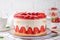 Fraisier mousse cake. Strawberry cake with biscuit, mousse and jelly on a white wooden background. Summer dessert. Selective focus