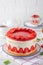 Fraisier mousse cake. Strawberry cake with biscuit, mousse and jelly on a white wooden background. Summer dessert. Selective focus