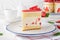 Fraisier mousse cake. Strawberry cake with biscuit, mousse and jelly on a white wooden background. Summer dessert. Selective focus