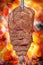 Fraldinha, bovine kind of flank steak, traditional brazilian barbecue whole piece on skewer isolated on blurred ember background