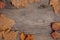 Frame of autumn leaves on a wooden background. Calm shades, weird, dusty color. Top view, flat lay