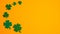 Frame border of shamrock four leaf clovers on orange background. Happy Saint Patrick s day concept. Greeting card, party