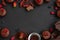 Frame with chocolate muffins, chocolate bars, cocoa and berries on dark wooden background. Top view. Flat lay