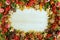 Frame from colorful autumn leaves, mushrooms, rose hips, rowanberry, apples, nuts and cookies on the wooden background.