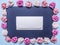 Frame of colorful paper roses, laid out on a dark background with an envelope middle top view close up place text