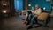 In the frame, an elderly couple sits on a couch in an apartment, against a blue wall. They are looking at, leafing