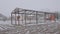 Frame of empty greenhouse in rural backyard in cold winter season on farmland