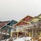 Frame Facade of mountain homes with horizontal siding balconies and outdoor stairs