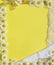 Frame from flowers of daisies, fabric and ruffle, gold ribbon and bow on a yellow background.