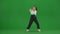 In the frame on a green background, chromakey. A young, slender, beautiful girl is dancing. She demonstrates various