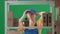 In the frame on a green background, a limp. Depicts a young woman in a uniform. Depicts an employee, in a warehouse. She