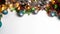 Frame green pine branch with Christmas balls, shiny tinsel, light and serpentine