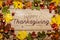 Frame HAPPY Thanksgiving DAY. Pumpkins, maple leaves and chestnuts on a wooden background. Congratulation