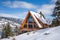 a-frame home against snowy hillside landscape