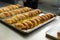 Frame image of an appetizing powdered sugar dusted pie baked on the tray, they are baked on table.