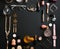 Frame made of perfume bottles, cosmetics and accessories on black background, flat lay