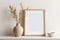 Frame mockup on beige table, modern beige ceramic vases on tray with dry grass. Photo frame, poster near white wall