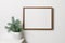 Frame mockup with copy space for artwork, photo or print presentation. White wall interior with christmas tree.