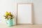 Frame mockup with flowers in mint green vase