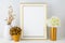 Frame mockup with ivory hydrangea in the golden vase, white vas