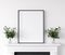 Frame mockup with plants standing on fireplace, white living room interior