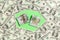 Frame of one hundred dollar bills with stack of money in the middle. Top view of business concept on green background with copy