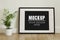 Frame, poster mock up with horizontal black frame. Empty frame standing on the wooden floor with a green plant. Free