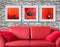 Frame with red poppy flora over the red couch