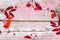 Frame of red Rowan berries with dry leaves on the background of an old wooden table with cracks of pink paint, copy space,