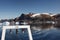 The A-frame of a research vessel is seen as it navigates around icebergs in a fjord in northwest Greenland