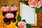 Frame of rose flowers and Christmas toy balls on romantic festive gold background of bokeh lights.