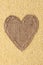 Frame in the shape of heart made of burlap with millet