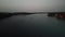 A frame shot on the drone. The river on which the boat rides on the background of a beautiful sunset.