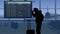 The frame shows an airport with a waiting room. The woman in the frame is going to the scoreboard, she missed her flight