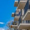 Frame Square Balconies of a residential building against blue sky and snowy mountain