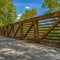 Frame Square Bridge overlooking luxuriant trees with bright green leaves against blue sky