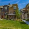 Frame Square Lush lawn in the middle of townhomes under blue sky on a sunny day