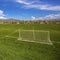 Frame Square Panorama of a soccer field with houses and mountain in the distance