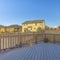 Frame Square Wooden deck of a house with stairs that goes down to the yard with snow