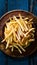 Frame Tempting french fries elegantly presented on a wooden plate