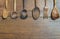 Frame of various antique wooden spoons and fork on vintage wooden background