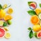 Frame of various citrus fruits with green leaves on white table, top view. Healthy lifestyle. Ingredients. Vitamin. Halves and