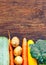 Frame of Vegetables still life in wooden background with copy space top view flatlay broccoli yellow squash potatoes carrots