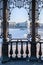 Frame of wrought gazebo on waterfront with buildings in center of Yekaterinburg in winter day.